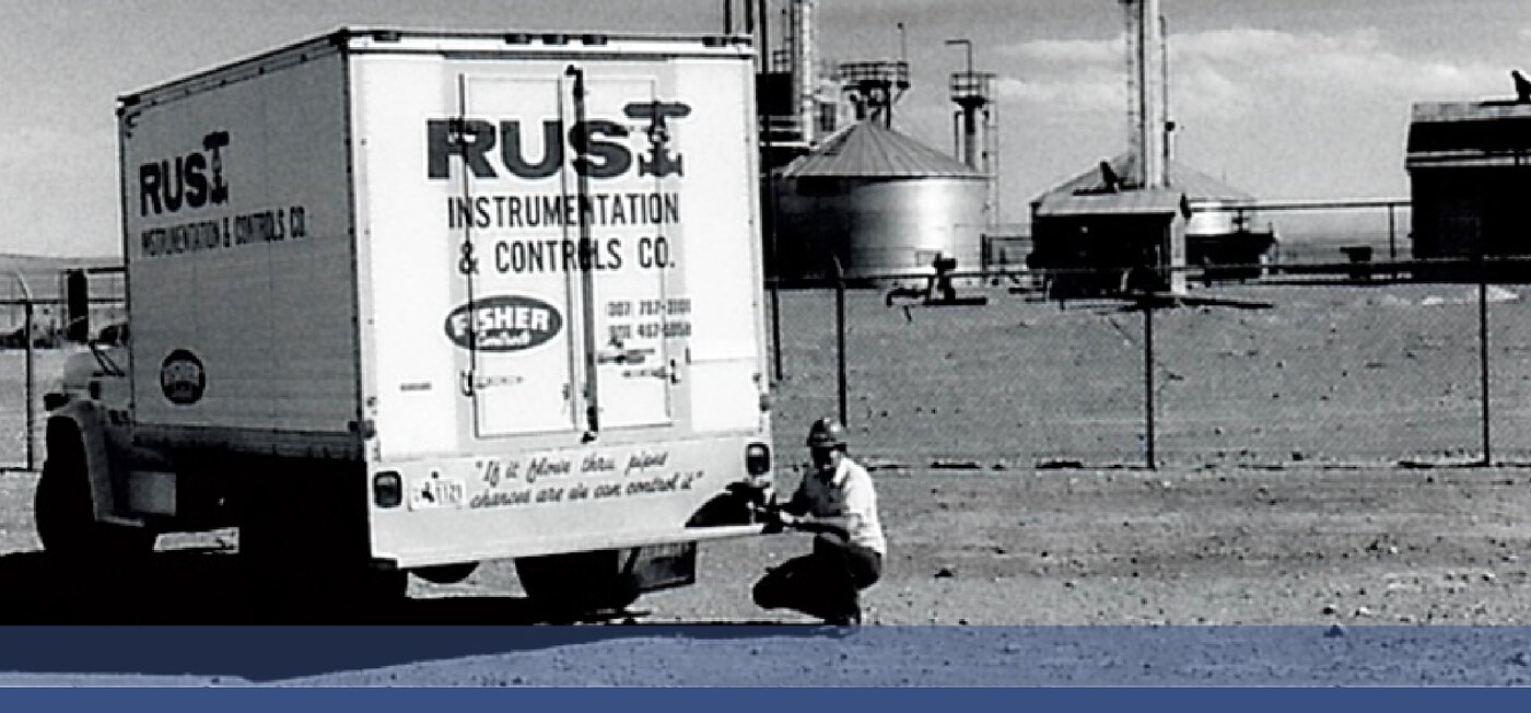 An early Rust Instrumentation & Controls Co. service truck at an industrial site